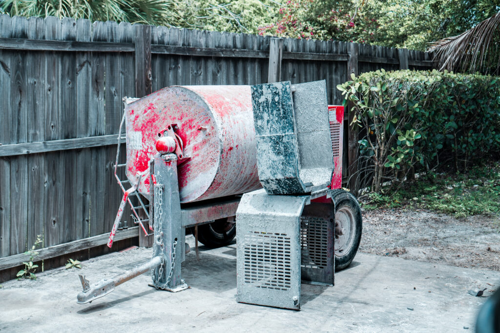 Portable red concrete mixer for rent at equipment rental yard.