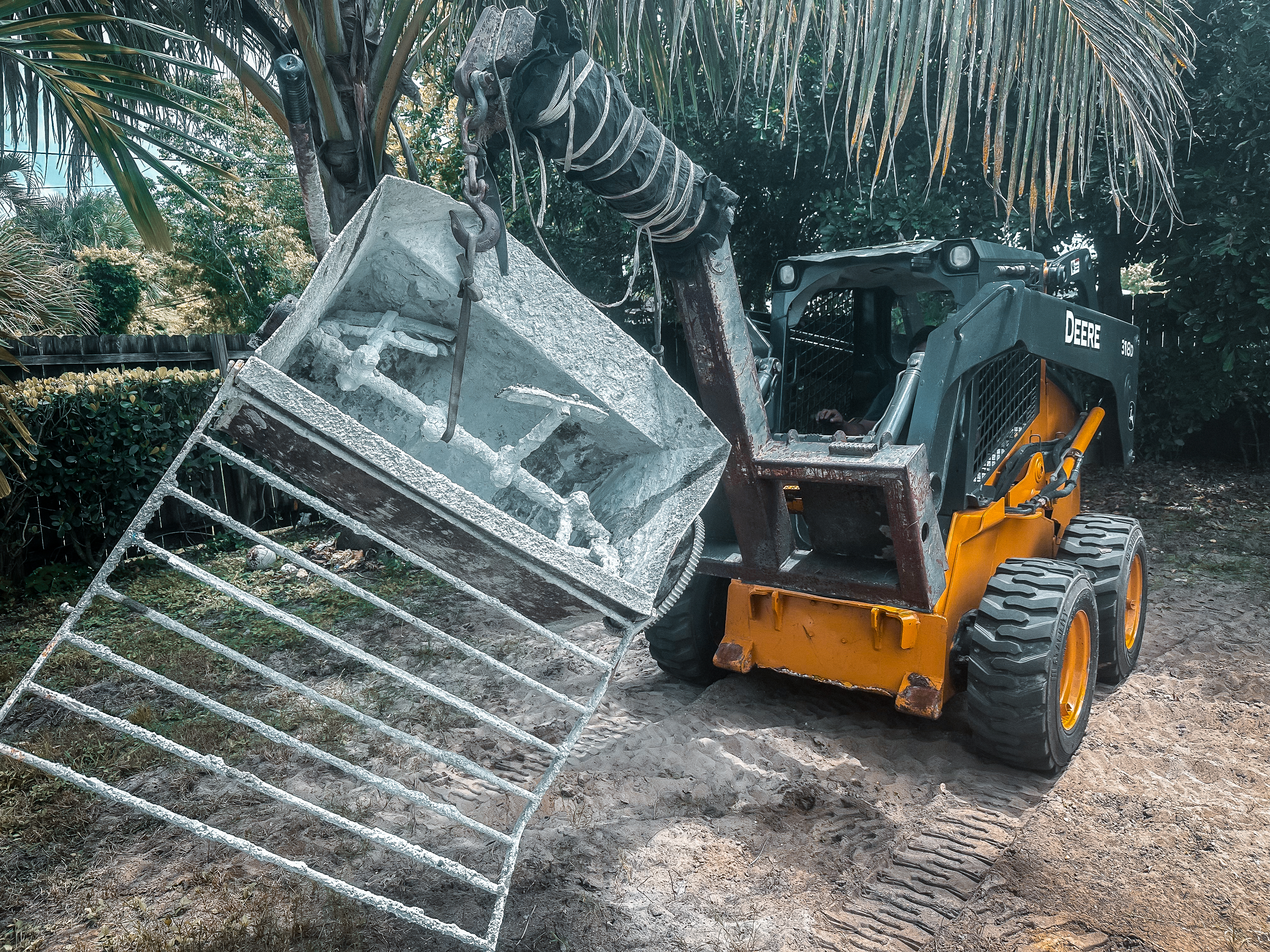 Skid steer lifting mortar mixer equipment.